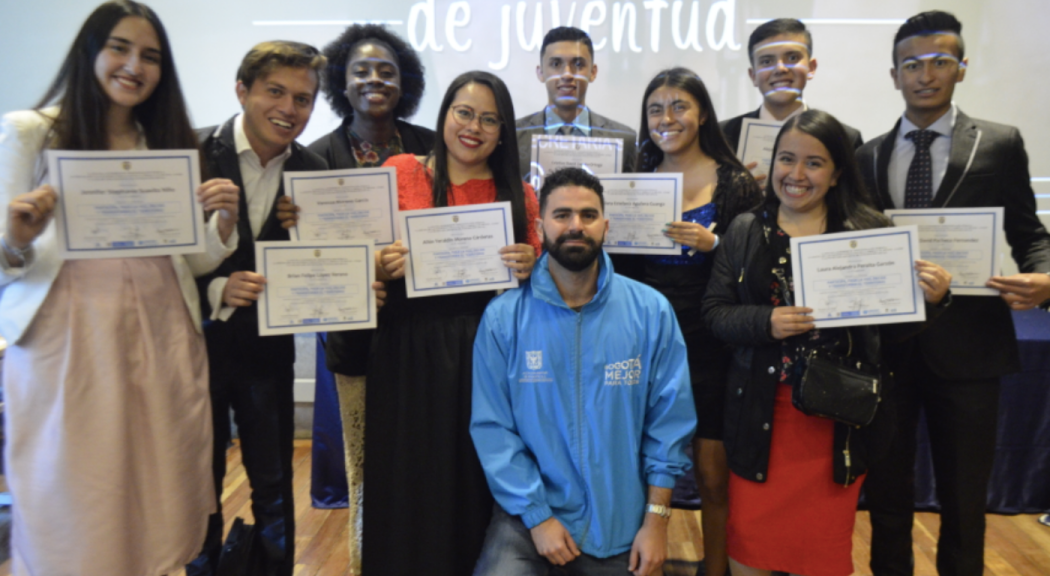 Un grupo de jóvenes sostienen diplomas.