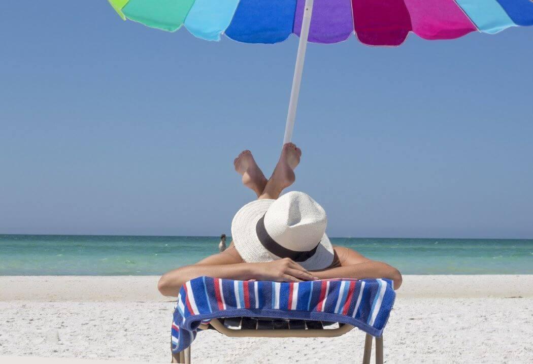 Imagen de una persona tomando el sol en la playa