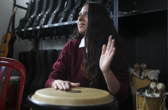 Joven mujer tocando un tambor.